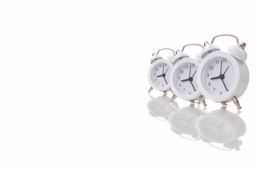 White alarm clock on white background