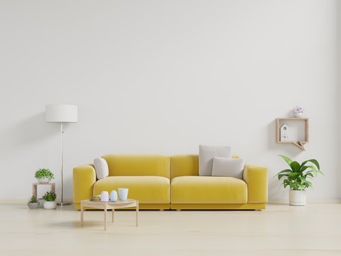 Living room with fabric yellow sofa,lamp and green plant in vase on white wall background.