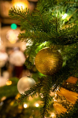 A Round Ornament Hanging from a Christmas Tree