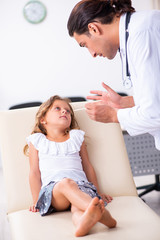 Fototapeta premium Young doctor pediatrician with small girl