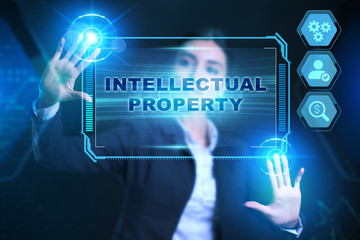 Obraz premium Business, Technology, Internet and network concept. Businessman presses a button Intellectual property on the virtual screen tablet future.