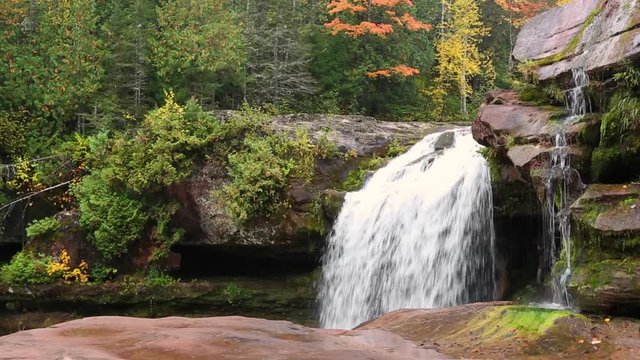 A remote waterfall, O Kun de Kun Falls, flows through a beautiful autumn landscape in the remote western Upper Peninsula of Michigan