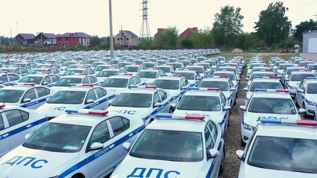 DPS Russian police cars many traffic standing on parking lot aerial view. Identical road police patrol cars in parking lot from drone above.