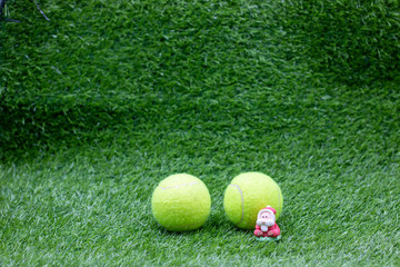 Tennis Christmas Holiday with Tennis balls and Santa Claus on green grass