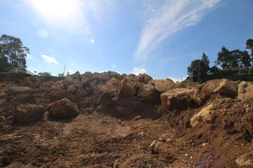 Fototapeta na wymiar stone quarries with lots of large boulders under the blue sky