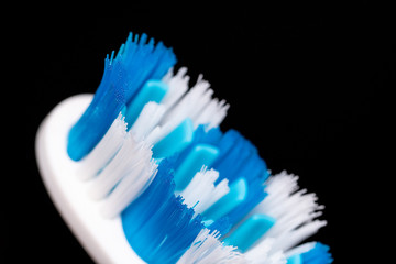 Blue white toothbrush bristles close up .