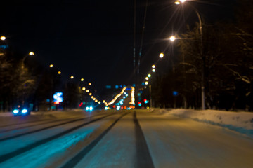 Fototapeta na wymiar Deep track in the snow on the roadway of a city street.