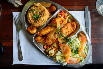 Caribeean fried fish with rice high angle view