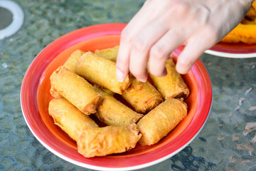 Hand picking traditional chinese spring rolls