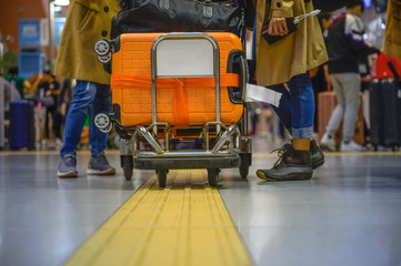 Many luggages carry in trolley in airport by woman traveller, busy in transports carry out of travellers in the airport