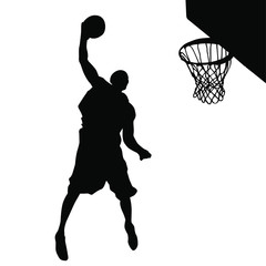 Vector silhouette of a basketball player dunking the ball. © LUGOSTOCK
