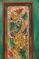 Close-up details of traditional balinese handmade carved wooden door. Bali style furniture with...
