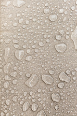 Texture of water drops on fabric textile close-up. Rain background in beige color. Waterproof surface abstract.  - 308368581