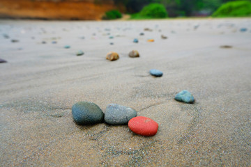 Close up of stone in the beach sand background with white stone. Sandy beach texture