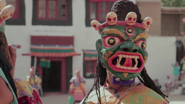 closeup of a mask being wore by a monk performing mask dance