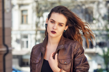Fototapeta premium Portrait of a young beautiful woman in the city