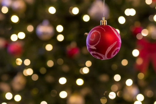 ornament hanging in front of blurry background christmas season - Powered by Adobe