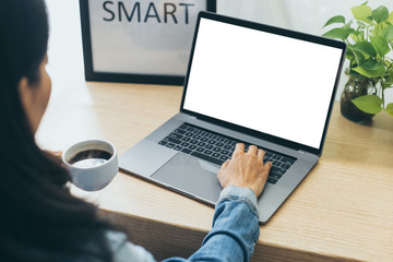 mockup image blank screen computer with blank white background for advertising text,hand man using laptop contact business search information on desk at home office.marketing and creative design