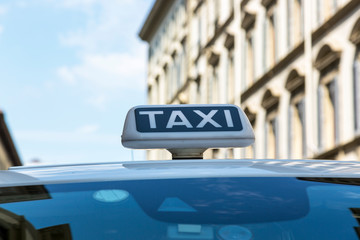 Checker taxi lighted rooftop car on a blurred background
