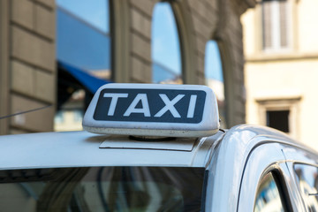 Checker taxi lighted rooftop car on a blurred background