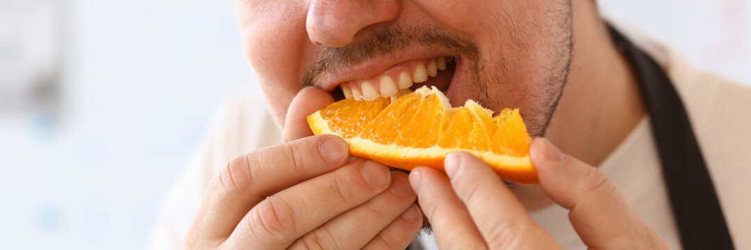 Man Chef Eating Juice Orange Kitchen Portrait - Powered by Adobe