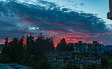 Flamboyant sunset over North Shore mountains overlooking UniverCity on Burnaby Mountain