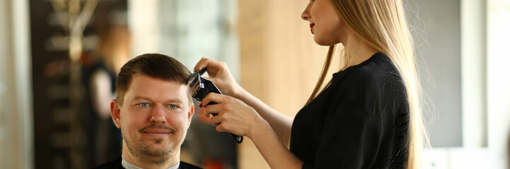 Woman Hairdresser Making Razor Haircut for Man