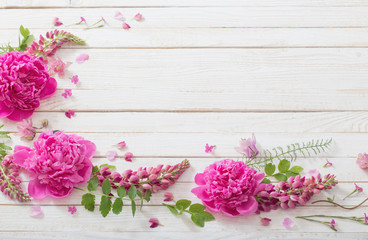 pink beautiful flowers on white wooden background