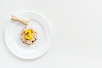 Birthday party for puppy concept. Dog feed, candle in shape of number three, bones on white background top-down copy space
