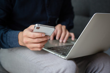 hand holding using texting cell phone and typing computer.businessman at workplace Thinking investment plan.chatting contact Investor.searching for information use internet.connecting people concept