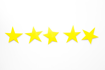Fototapeta premium Customer experience concept. Estimate service quality. Five stars on white background top-down copy space
