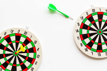 Darts game - simple sport for lesure time. Dartboard and arrows or dart on white background top...