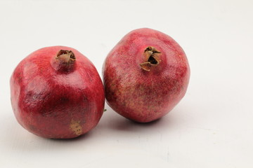 Red Pommegranate on a wooden background with copy space.