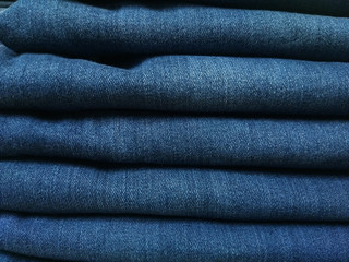Close-up old Jeans trousers stack background texture.