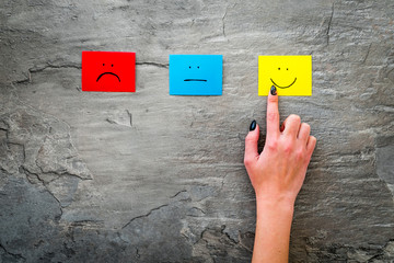 Positive feedback, good service concept. Hand touch happy smile on grey background top-down copy...
