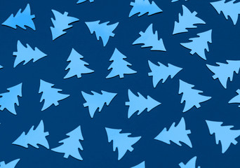 Christmas trees on a blue background. Color of the year 2020. Monochrome. Photograph of decorative elements. New year backdrop. Top view. Ecology concept.