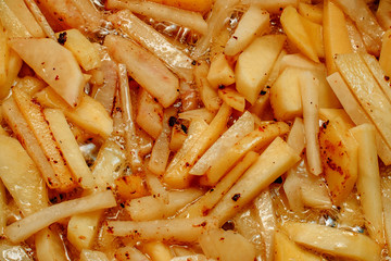 Potatoes in boiling oil close up
