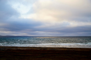 Norway landscape with beach of the Northern sea in cloudy weather