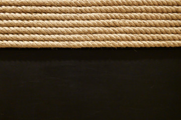 Dark brown wooden textured wallpaper with half light beige round rope roll braid detail vintage...