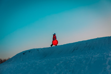 young boy go to slide in winter snow, winter kids activities