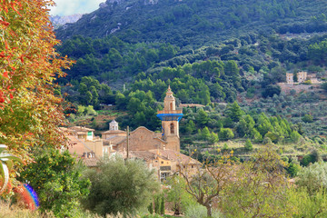 Fototapeta premium The bell tower of an old church in the village of Palma de Mallorca.