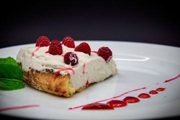 Raspberry cheesecake on black background