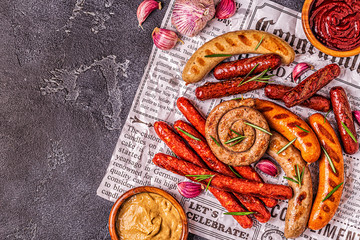 Homemade sausages grilled on a newspaper.