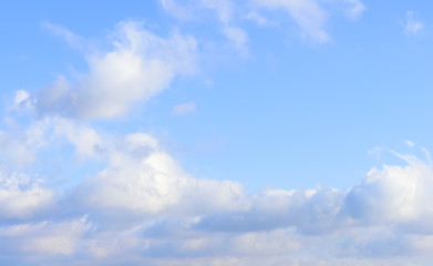 Naklejka na ściany i meble Puffy clouds against blue sky wallpaper background