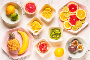 Tropical fruits whole and slices on plates