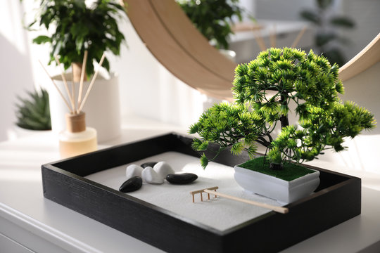 Beautiful miniature zen garden on white table indoors