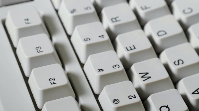 Finger presses F2 button on keyboard
