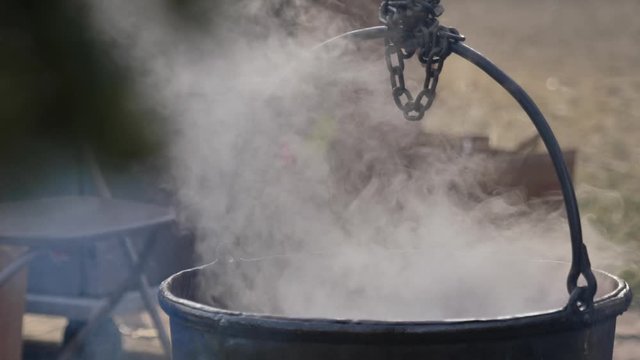Steaming cauldron outside close up