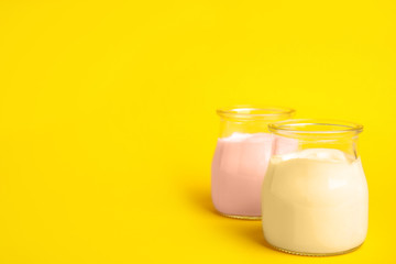 Tasty organic yogurt on yellow background. Space for text