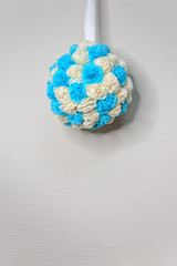 Composition of white and blue flowers, close-up. Artificial fabric flowers on white background, abstract vertical image.